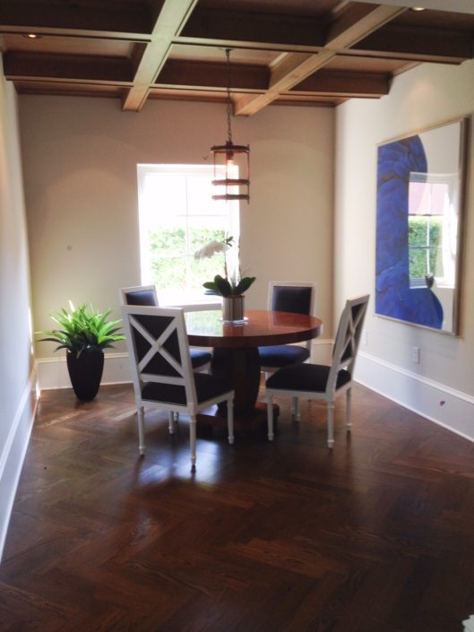 A dining room with a table and chairs