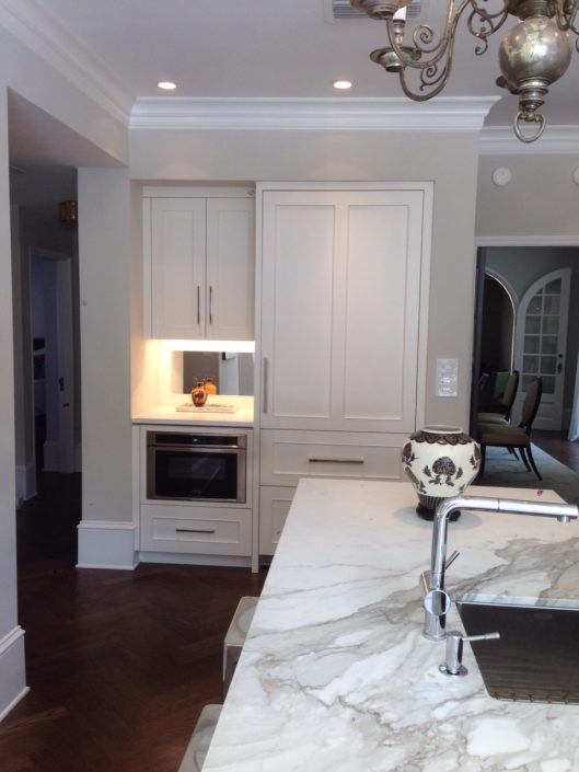 A room with white walls and wooden floors.