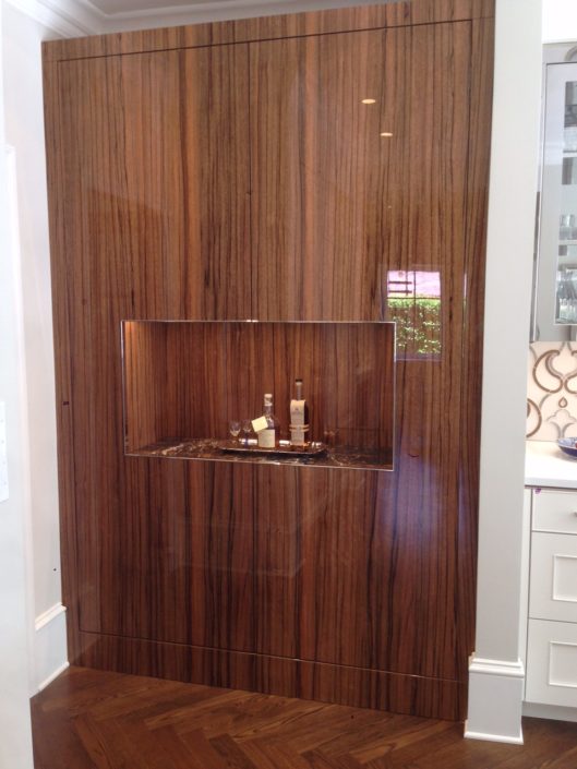 A wooden cabinet with a sink and mirror in it.