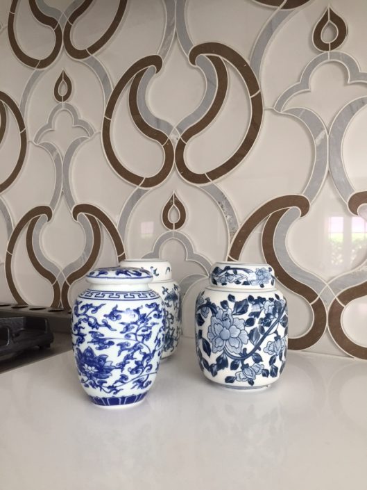 Two blue and white vases on a table.