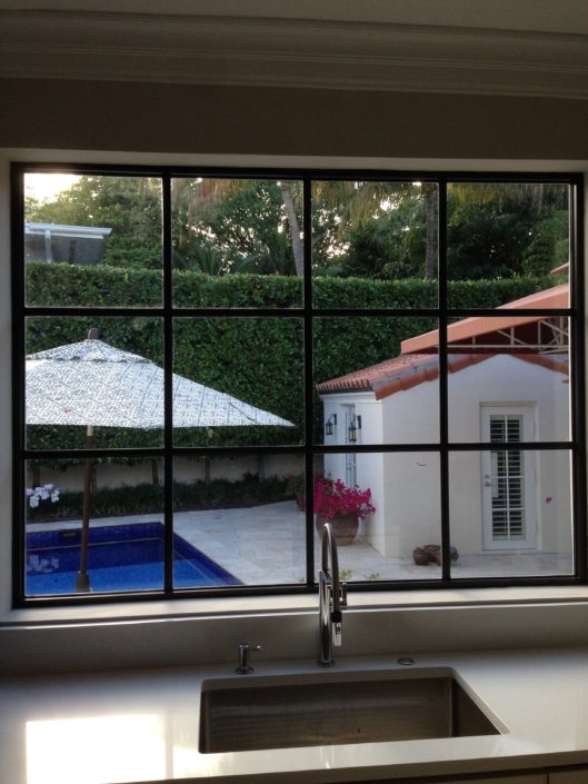 A view of a pool from inside the house.