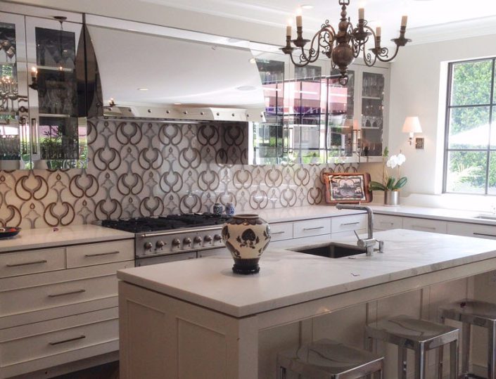 A kitchen with a sink, stove and counter.