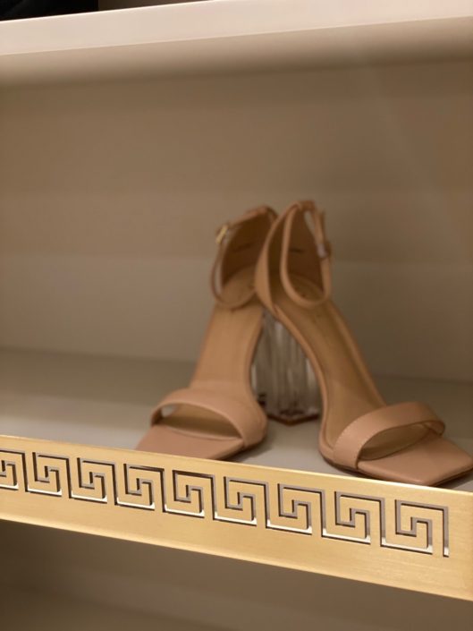 A pair of shoes sitting on top of a shelf.