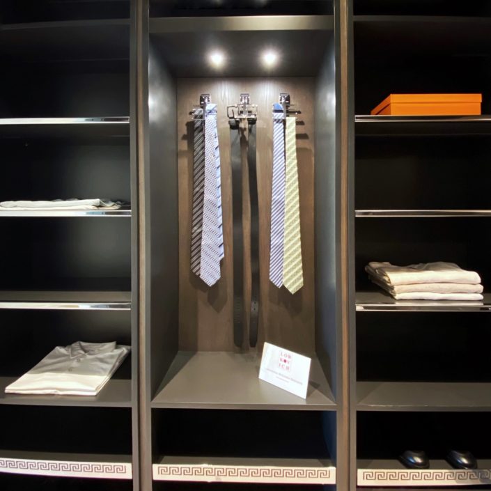 A closet with shelves and a light on the top.