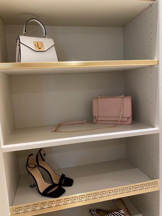 A shelf with shoes and purses on it