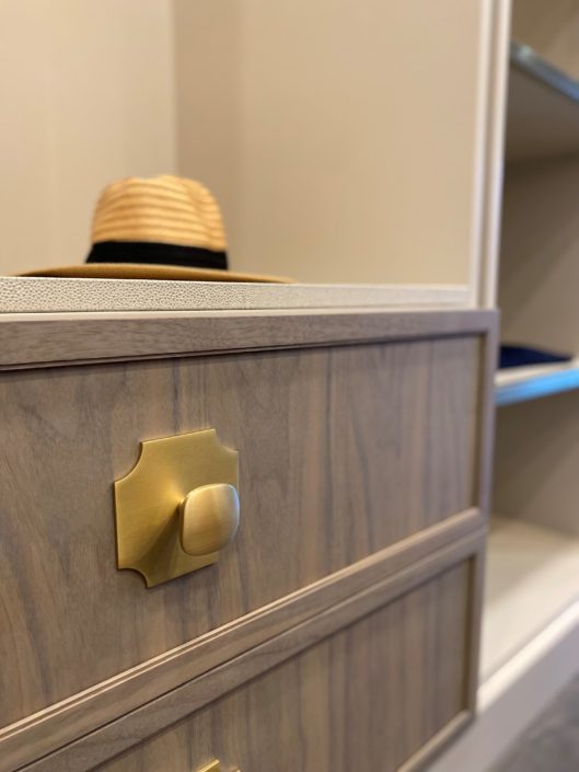 A hat is on the wall of a closet.